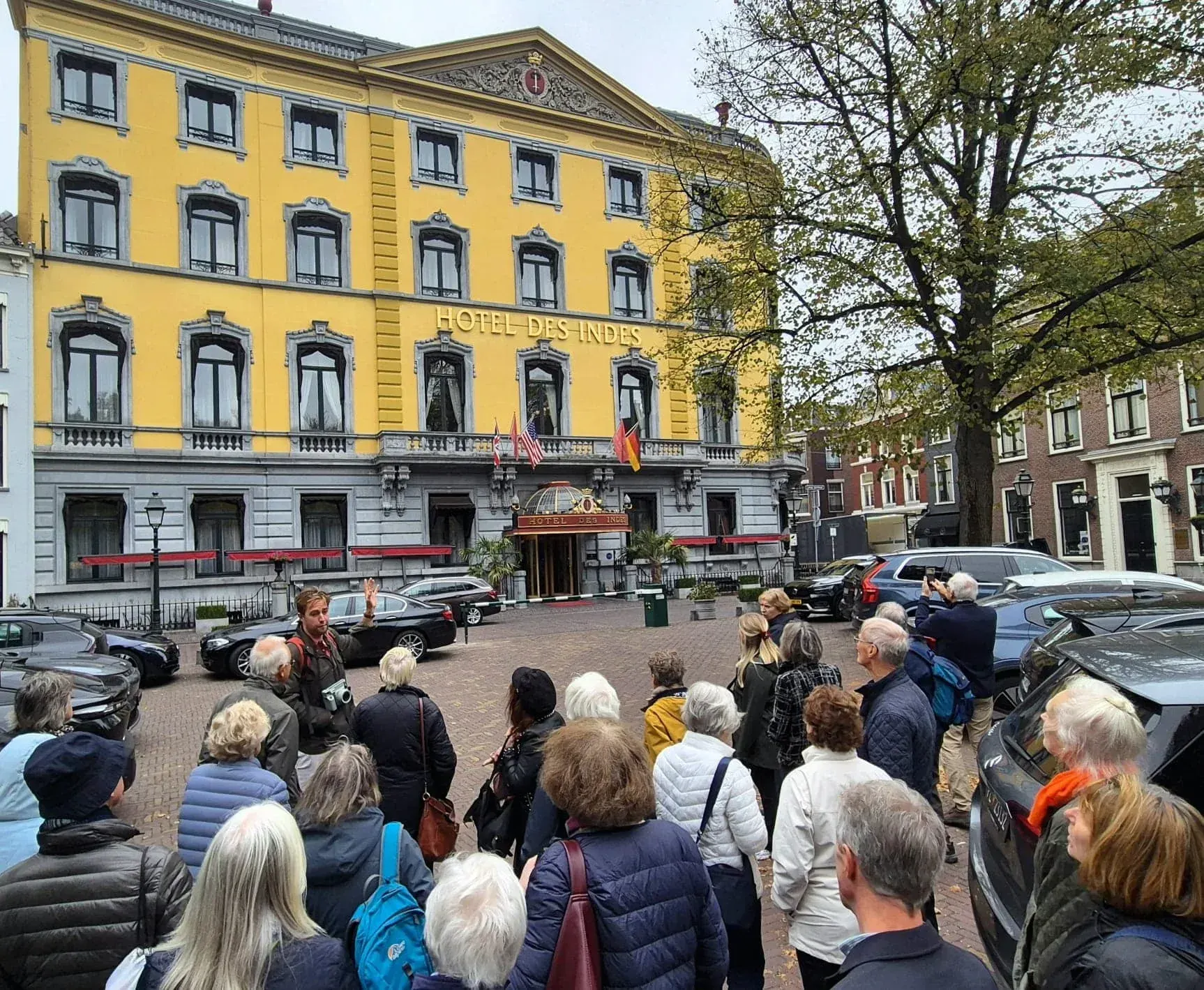A guide and tour group in front of Hotel des Indes on the Lange Voorhout, The Hague