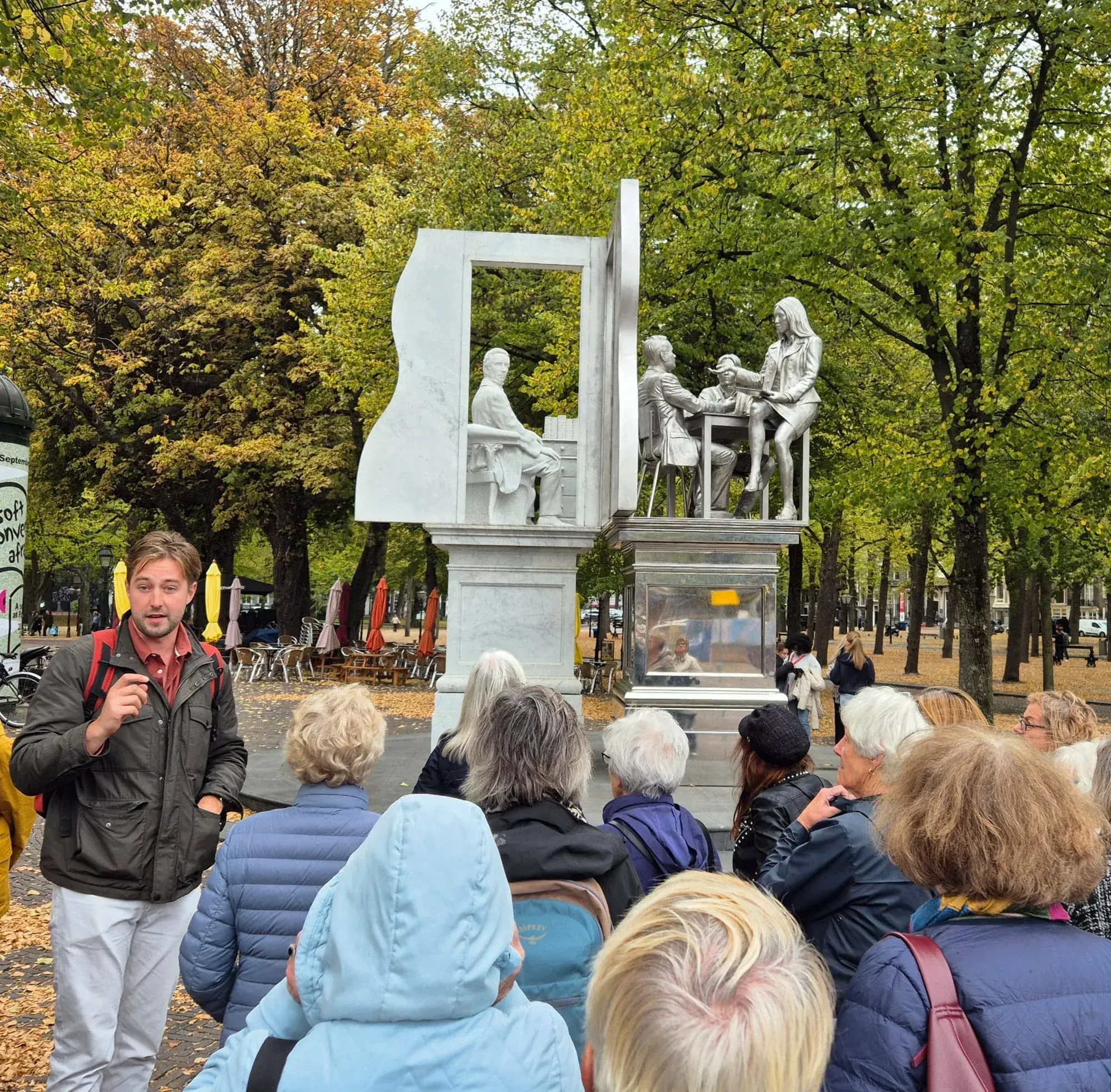 A guide and tour group at the Thorbecke monument on the Lange Voorhout, The Hague