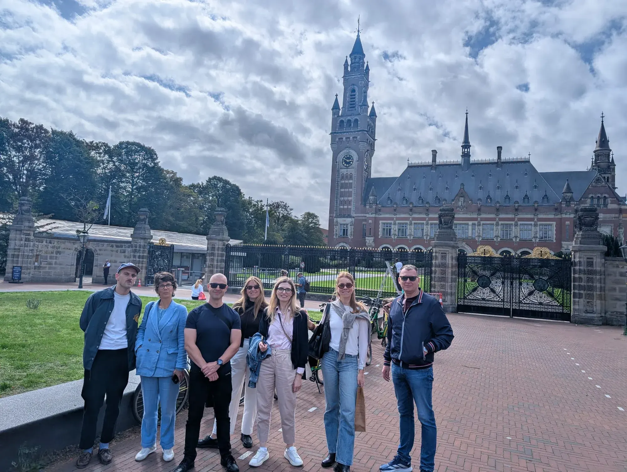 A tour group at the gates of the Peace Palace in The Hague
