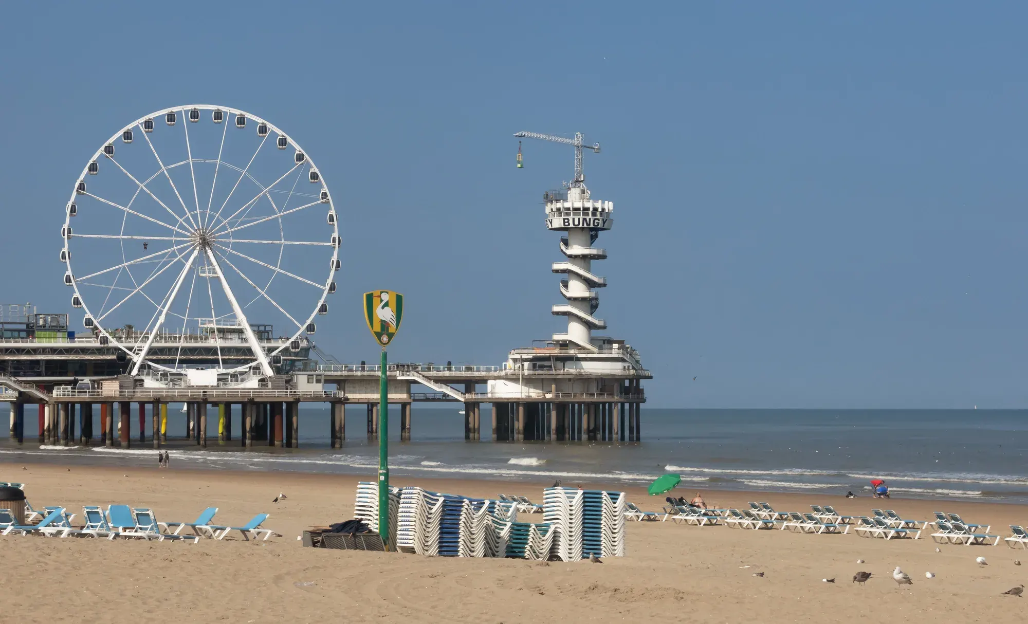 De Pier at Scheveningen with its Ferris wheel and bungee tower, seen from the beach