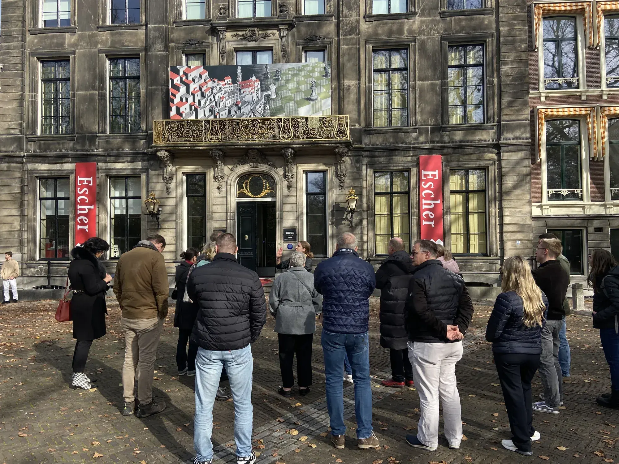 A tour group looking at the Escher exhibition inside Escher in Het Paleis, a former royal palace in The Hague