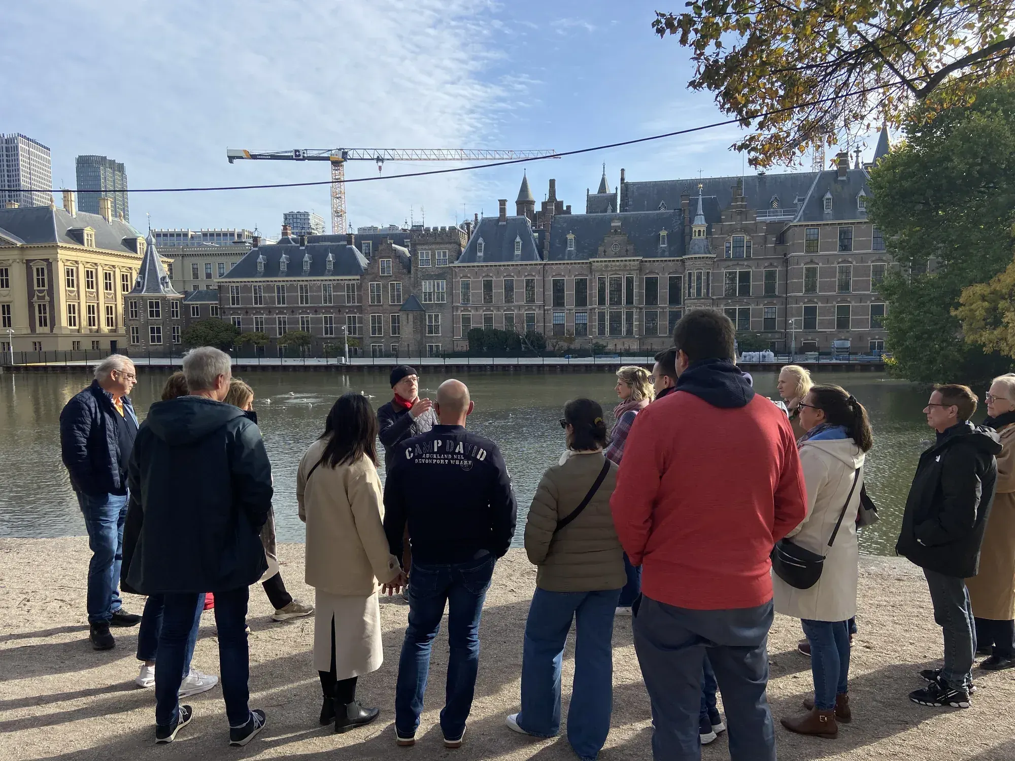 A tour group at the Hofvijver looking across to the Binnenhof, the Dutch parliament, The Hague
