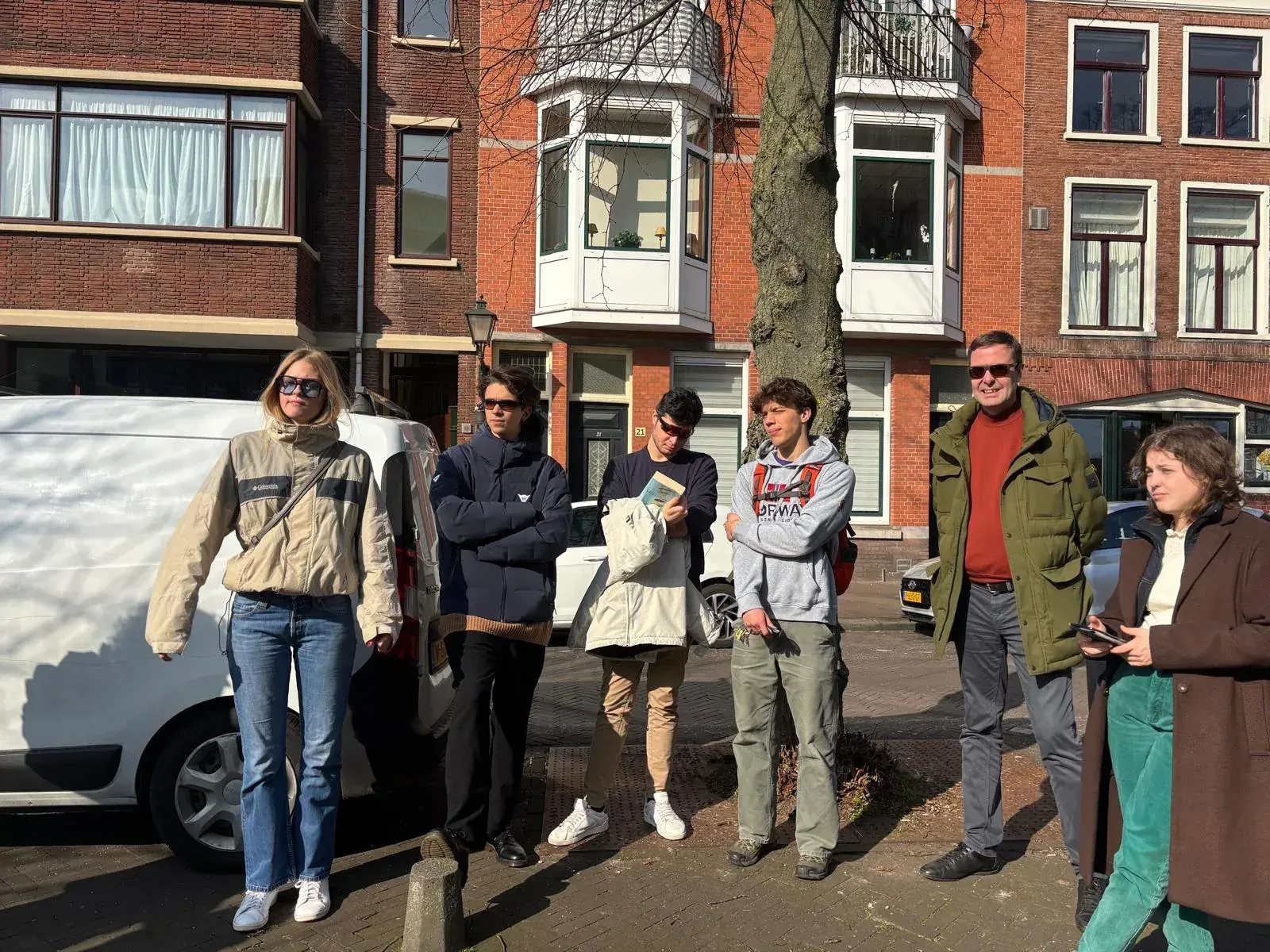 A private tour group walking down a quiet residential street in the centre of The Hague